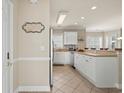 Bright kitchen featuring white cabinetry, a breakfast bar, and neutral countertops at 4890 Luster Leaf Circle # 201, Myrtle Beach, SC 29577