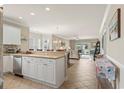 Open kitchen with stainless steel appliances, breakfast bar, and view into living area at 4890 Luster Leaf Circle # 201, Myrtle Beach, SC 29577