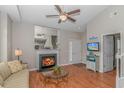 Cozy living room featuring a fireplace, hardwood floors, neutral walls, and a seamless transition to the staircase at 503 20Th Ave. N # 15B, North Myrtle Beach, SC 29582