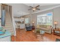 Inviting living room with hardwood floors, ceiling fan, and a seamless transition to the dining area at 503 20Th Ave. N # 15B, North Myrtle Beach, SC 29582