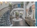 The grand foyer features a spiraling staircase, with custom carpet and high-end finishes and decor at 510 Rum Gully Rd., Murrells Inlet, SC 29576