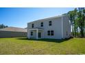 Spacious backyard featuring a covered patio and plenty of room for outdoor activities on a manicured lawn at 579 Strawberry Field Way, Galivants Ferry, SC 29544