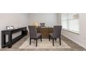 Serene home office bathed in neutral tones, laminate wood flooring, and ample space to get work done at 579 Strawberry Field Way, Galivants Ferry, SC 29544