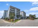 Image of the condominium complex entrance showcasing well maintained landscaping and covered entry at 5905 South Kings Hwy. # 132B, Myrtle Beach, SC 29575