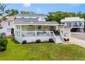 Charming home with a covered porch, manicured lawn, and dedicated golf cart parking for convenient living at 6001 -6010 S Kings Highway, Myrtle Beach, SC 29575