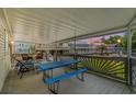 Relaxing covered porch with a blue picnic table and comfortable seating, perfect for outdoor entertaining at 6001 -6010 S Kings Highway, Myrtle Beach, SC 29575