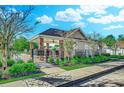 Inviting community pool area with ample seating, lush landscaping, and a covered pavilion at 617 Chiswick Dr., Conway, SC 29526