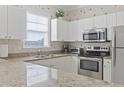 Well-lit kitchen with granite countertops, stainless steel appliances and white cabinets at 6253 Catalina Dr. # 534, North Myrtle Beach, SC 29582