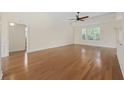 Spacious living room boasting wood floors, neutral walls, large windows, and a ceiling fan at 837 Sand Binder Dr., Myrtle Beach, SC 29579