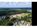Community aerial showing golf course, ponds, and wooded areas; ideal setting near established neighborhoods at 9724 Indigo Creek Blvd., Murrells Inlet, SC 29576