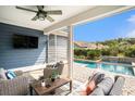 Relaxing screened porch with wicker furniture and a view of the private pool and landscaped backyard at 981 Mourning Dove Dr., Myrtle Beach, SC 29577