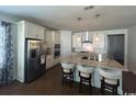 Open concept kitchen features a center island, stainless appliances, and white cabinets at 1039 Graybill Lane, North Myrtle Beach, SC 29582