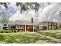 Traditional brick home with a manicured lawn and mature trees offering shade at 104 East Bay St., Georgetown, SC 29440