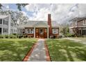 Inviting brick home with well-manicured lawn and a brick walkway leading to the front door at 104 East Bay St., Georgetown, SC 29440