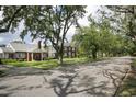 Neighborhood street showcasing traditional brick homes and mature trees, creating a welcoming atmosphere at 104 East Bay St., Georgetown, SC 29440