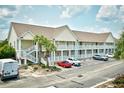 Charming condo complex with staircases and balconies, surrounded by lush landscaping at 109 Butkus Dr. # 2-1, Myrtle Beach, SC 29588