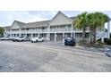 Accessible condo building featuring a ramp and ample parking near palm trees at 109 Butkus Dr. # 2-1, Myrtle Beach, SC 29588