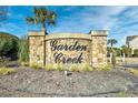 Elegant stone sign displaying 'Garden Creek' amidst lush landscaping welcomes visitors at 109 Butkus Dr. # 2-1, Myrtle Beach, SC 29588