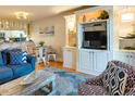 Open living area with stylish furnishings, built-in shelving and cabinets, and adjacent dining area at 1212 Ocean Blvd. S # 202, Surfside Beach, SC 29575