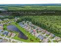 Aerial view of a quiet street in the Prince Creek community, surrounded by lush green trees and a pond at 1227 Cypress Shadow Ct., Murrells Inlet, SC 29576