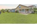 Expansive backyard featuring a well-maintained lawn with view of covered porch at 1227 Cypress Shadow Ct., Murrells Inlet, SC 29576