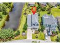 Aerial view of a charming home with a well-manicured lawn and a scenic view of the adjacent pond at 126 Dreamland Dr., Murrells Inlet, SC 29576