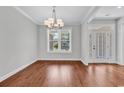 Elegant dining room with hardwood floors, chandelier, and ample natural light at 133 Deloach Trail, Pawleys Island, SC 29585