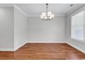 Bright dining room with hardwood floors and modern chandelier at 133 Deloach Trail, Pawleys Island, SC 29585