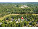 An aerial view showing the home's location near a golf course, trees, and water at 168 Mackinley Circle, Pawleys Island, SC 29585