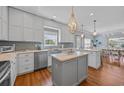 Bright kitchen with a large island, stainless steel appliances, and modern fixtures, adjacent to the dining area at 1705 N Ocean Blvd. N, North Myrtle Beach, SC 29582