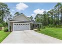 Charming single-story home with attached garage, long driveway, landscaping and a manicured lawn at 173 Crossroad Dr. Nw, Calabash, NC 28467