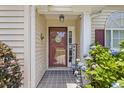 Close-up of a lovely front entrance featuring a decorative door, sidelights, and colorful landscaping at 1776 Starbridge Dr., Surfside Beach, SC 29575