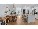 Inviting open floorplan showcases a dining area and kitchen with modern amenities and breakfast bar seating at 196 Cypress Tree Loop, Longs, SC 29568