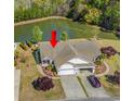 Aerial view of home, highlighting the surrounding lush landscaping and serene pond at 204 Rose Water Loop # 204, Myrtle Beach, SC 29588