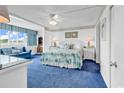 Well-lit primary bedroom with blue carpet and beach-themed decor at 2511 S Ocean Blvd. # 507G, Myrtle Beach, SC 29577