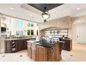 Bright kitchen with large windows, custom island, stainless steel appliances, and stone accents at 2715 Ships Wheel Dr., North Myrtle Beach, SC 29582