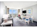 Cozy living room features modern decor and a calming color palette with ocean view balcony at 300 N Ocean Blvd. # 723, North Myrtle Beach, SC 29582
