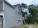 This two-story home features gray siding, white trim, and windows at 3038 Palma Way, Myrtle Beach, SC 29579