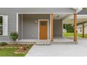 Inviting front porch showcasing a wooden door and covered carport at 306 S Magnolia Ave., Andrews, SC 29510