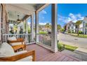 Relaxing front porch view with comfortable seating and a glimpse of the neighborhood street at 3477 Bristol Ln. # 3477, Myrtle Beach, SC 29577