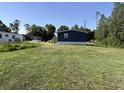 View of the back of the single-story home and large lawn at 401 Cessna St, Myrtle Beach, SC 29577