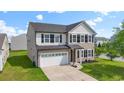 Charming two-story home with a white garage door, dark shutters, and a well-manicured lawn at 4115 Alvina Way, Myrtle Beach, SC 29579