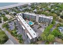 Breathtaking aerial view of this condo building, featuring a sparkling swimming pool and convenient parking at 423 Parker Dr. # 334, Pawleys Island, SC 29585