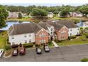 Scenic aerial view of condo building near a pond, trees, and parking lot at 4387 Daphne Ln. # B, Murrells Inlet, SC 29576