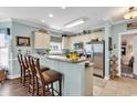 Well-lit kitchen featuring stainless steel appliances, breakfast bar, and modern finishes at 4820 Magnolia Lake Dr. # 305, Myrtle Beach, SC 29577