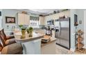 Charming kitchen featuring stainless steel appliances, breakfast bar, and ample cabinet space at 4820 Magnolia Lake Dr. # 305, Myrtle Beach, SC 29577