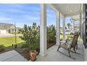 Comfortable front porch with chairs and views of the landscaped yard at 519 Royal Jay Ln., Longs, SC 29568