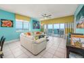 Bright living room with a view of the ocean and access to balcony at 5700 N Ocean Blvd. # Ph12, North Myrtle Beach, SC 29582