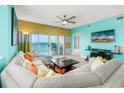 Bright living room with ocean view through sliding glass doors to balcony at 5700 N Ocean Blvd. # Ph12, North Myrtle Beach, SC 29582
