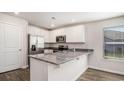 Modern kitchen with stainless steel appliances, granite countertops, and ample cabinet space at 575 Strawberry Field Way, Galivants Ferry, SC 29544
